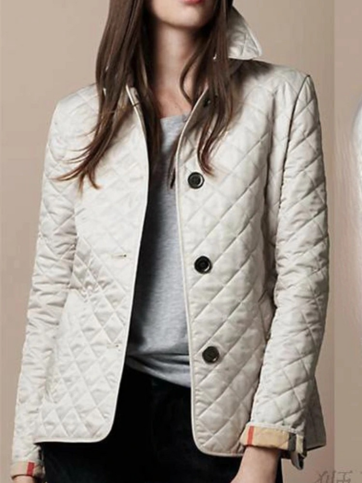Stylish women's quilted jacket, a versatile layering piece with a classic turned-down collar for fall & winter fashion.