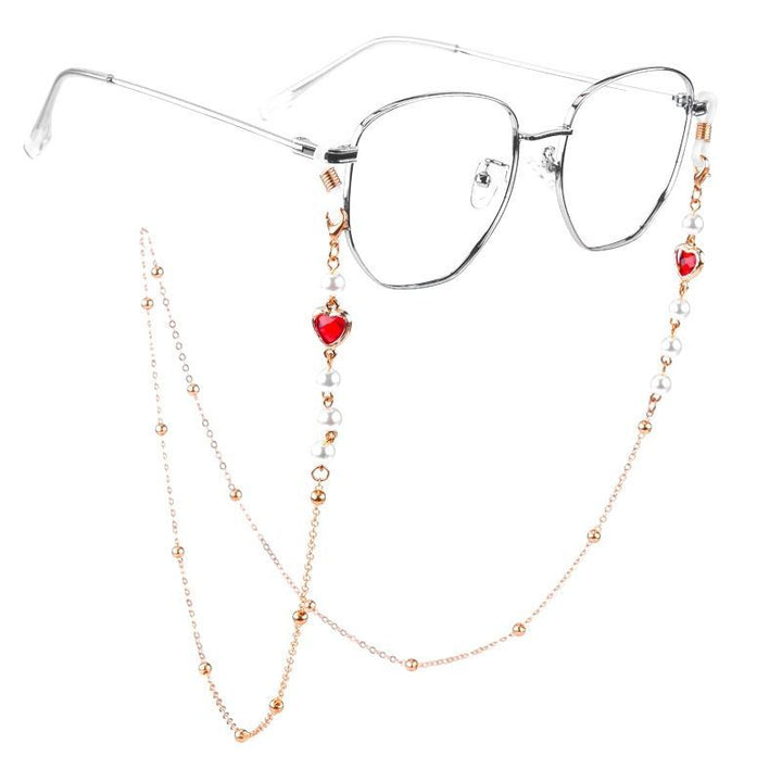 Women's fashion glasses chain featuring heart & pearl pendants. Practical and elegant eyewear holder accessory.