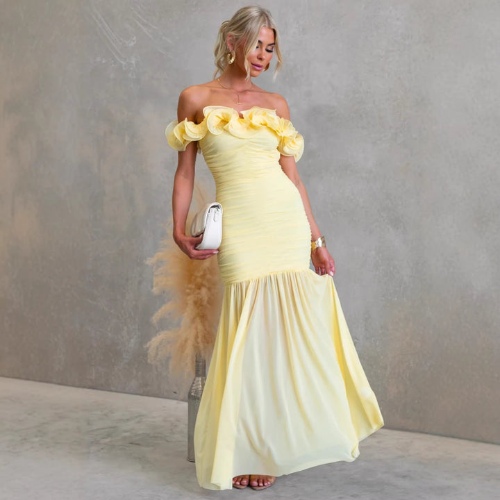 Flowing off-shoulder ruffled maxi dress for women, ideal as a sophisticated wedding guest gown.