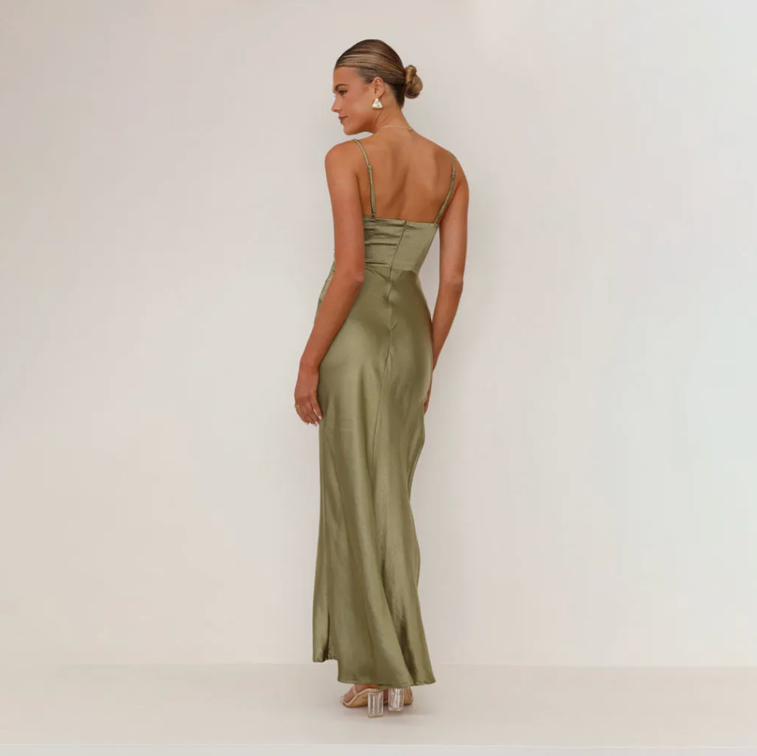Glamorous women's formal occasion wear, featuring a satin look, draped ruching, & a chic split design.