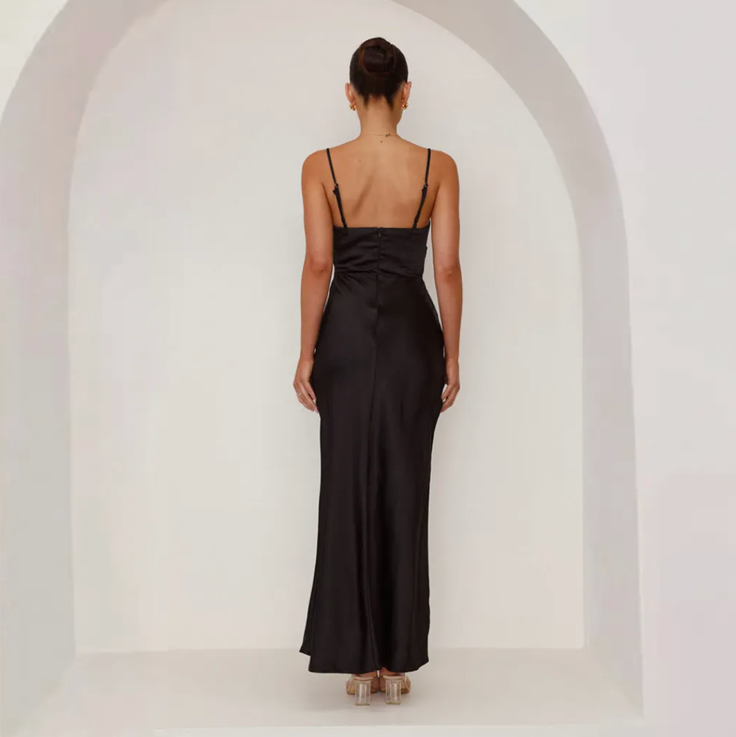 Chic black women's evening gown with a silky satin look, elegant ruching, & a dramatic side split.