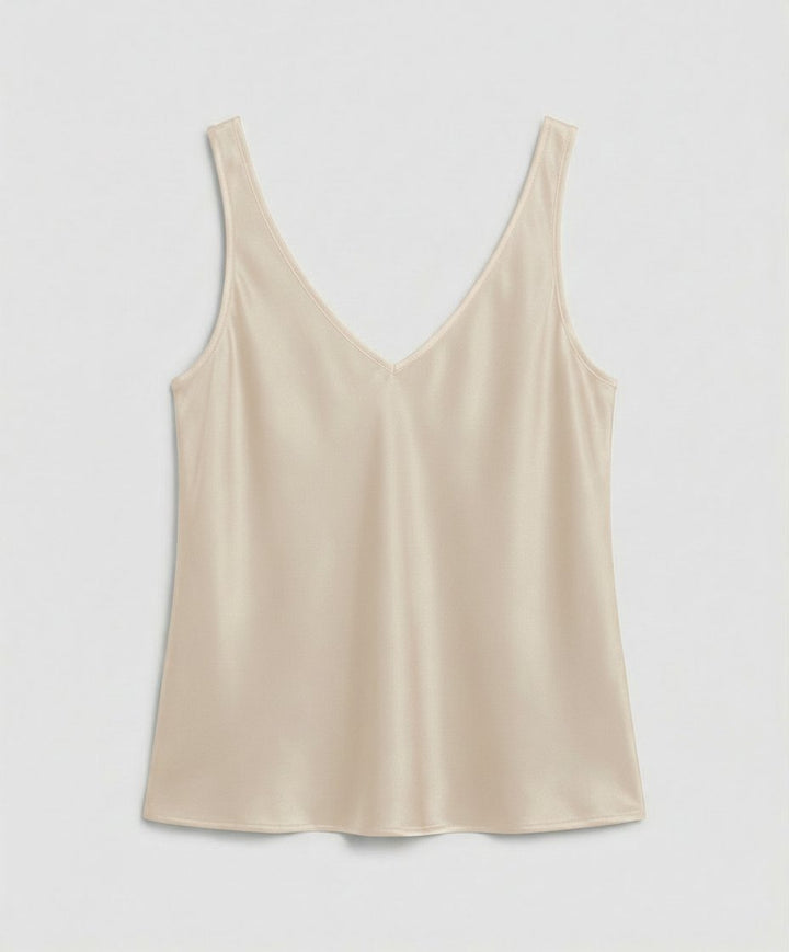 Close-up of a women's satin V-neck camisole top, highlighting the elegant wide straps and silky fabric texture.