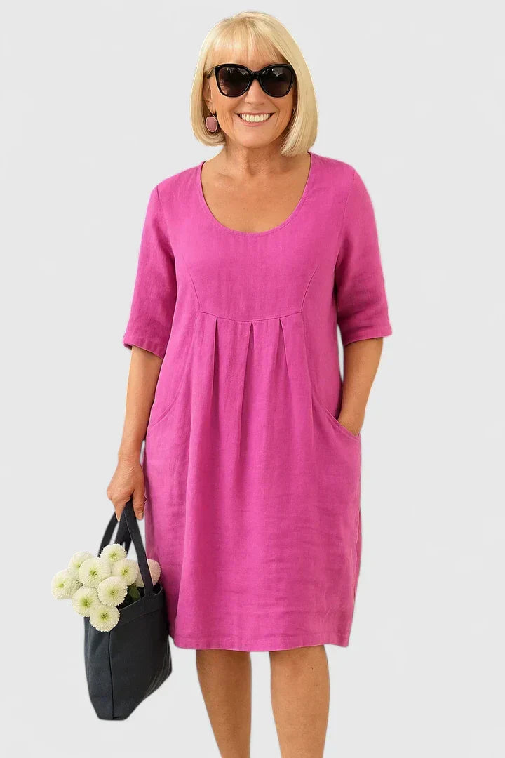 Comfortable scoop neck women's dress, relaxed fit, half sleeve, with pockets; perfect for versatile everyday wear.