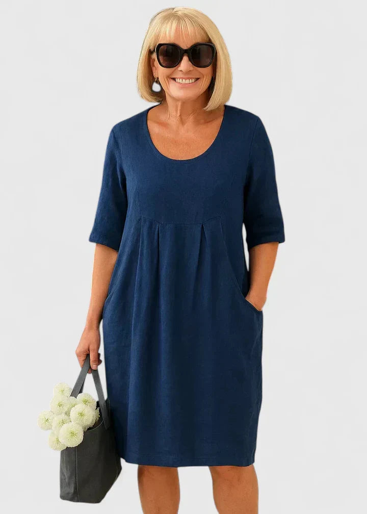 Women's relaxed fit scoop neck dress with half sleeves and functional pockets, offering comfort and style.