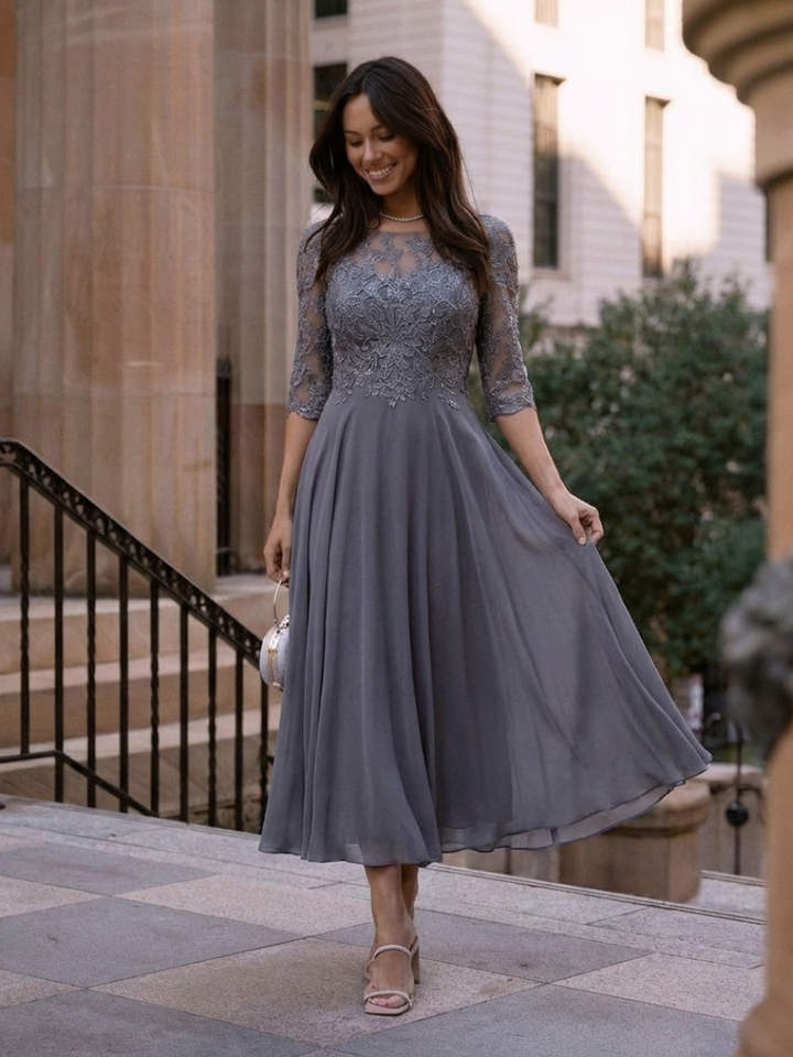 Elegant women's midi dress with sheer sleeves and detailed designed top, great for formal parties.