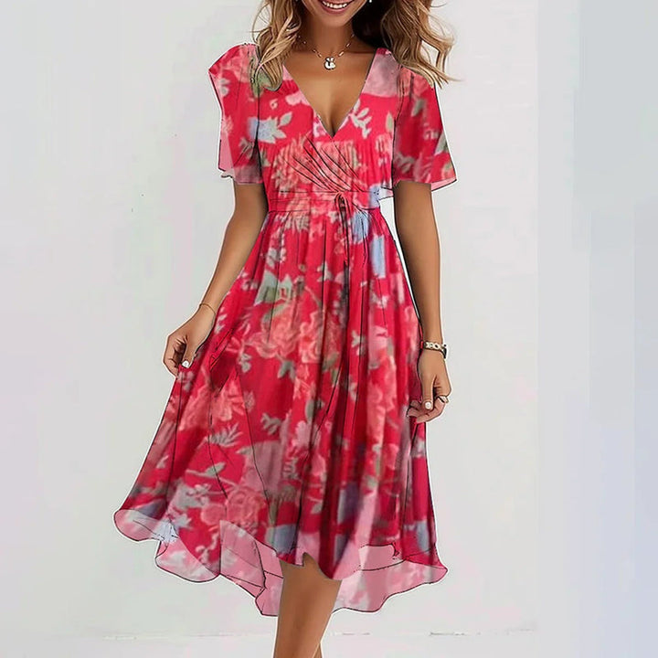 Versatile women's printed short sleeve dress with V-neck & unique asymmetrical hem. Ideal elegant summer wear.