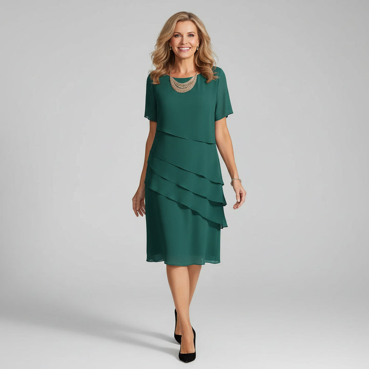 Chic women's tiered midi dress with short sleeves. A flowy, elegant summer dress, comfortable for any party or occasion.