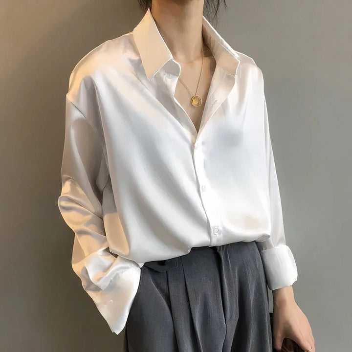 Green silky button-down long sleeve blouse for women with pointed collar, ideal for elegant office wear.