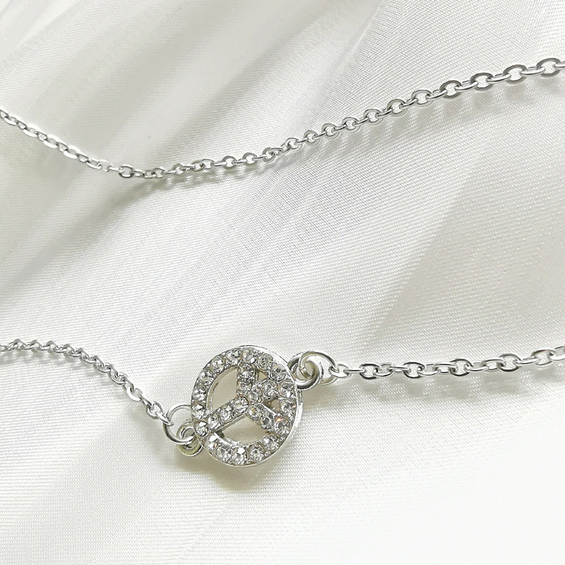 Beautiful women's jewelry: an elegant silver filigree peace sign pendant necklace, versatile for any look.