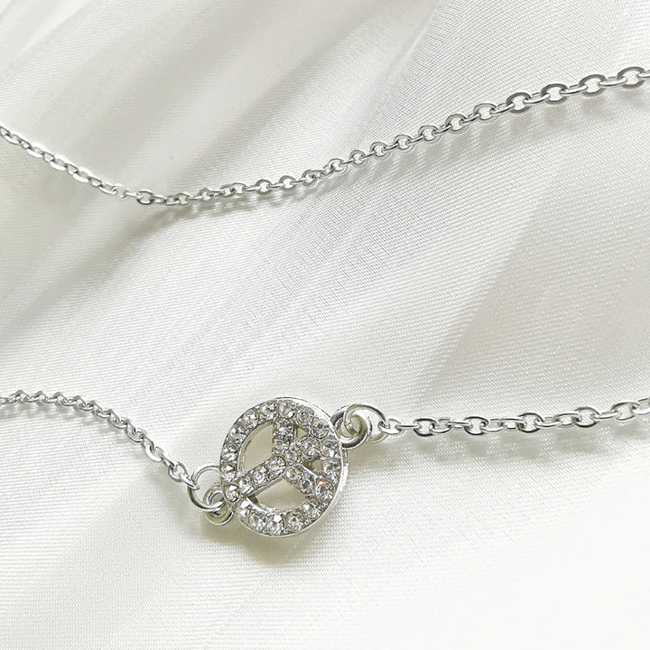 Beautiful women's jewelry: an elegant silver filigree peace sign pendant necklace, versatile for any look.