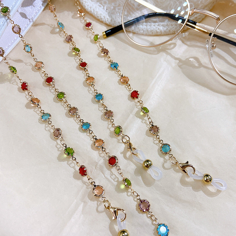 Sparkling women's jewelry: elegant silver-plated filigree necklace with colorful crystals and glitter accents.