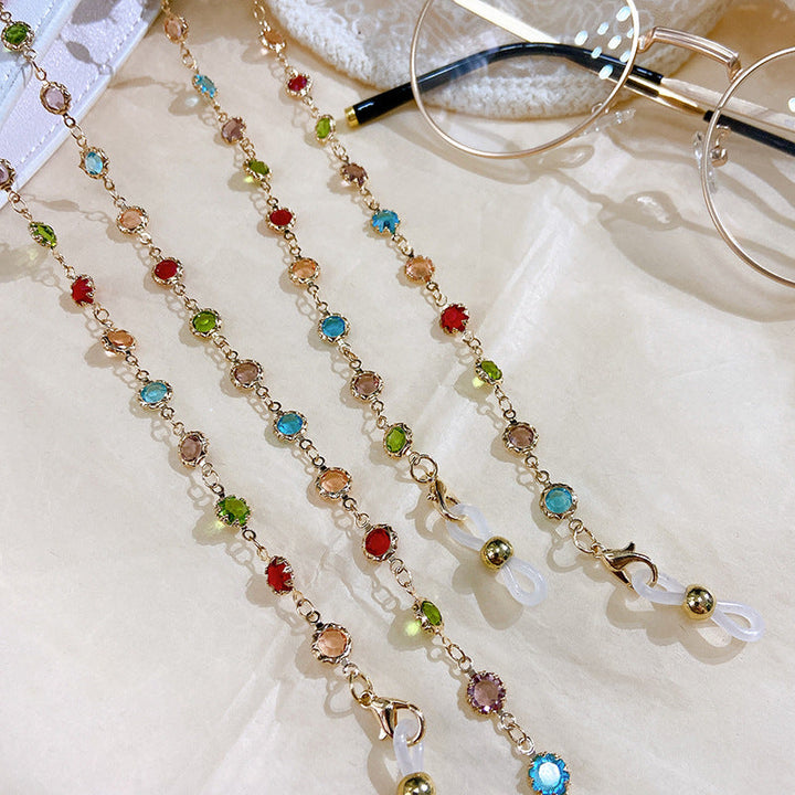 Sparkling women's jewelry: elegant silver-plated filigree necklace with colorful crystals and glitter accents.