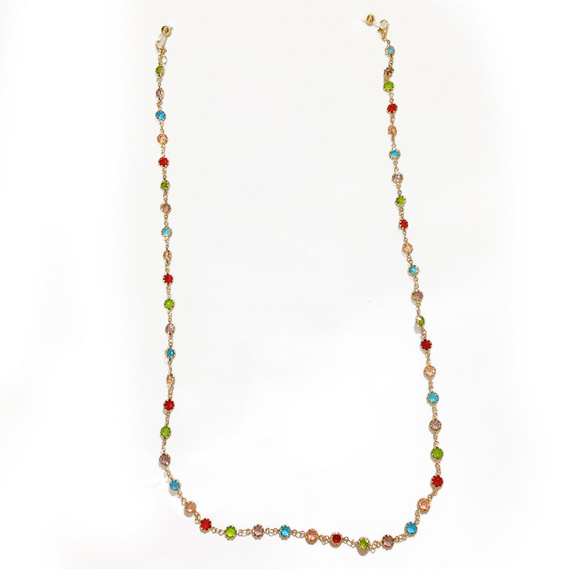Women's sparkling silver-plated filigree necklace with glitter and an array of colorful crystals. Elegant jewelry.