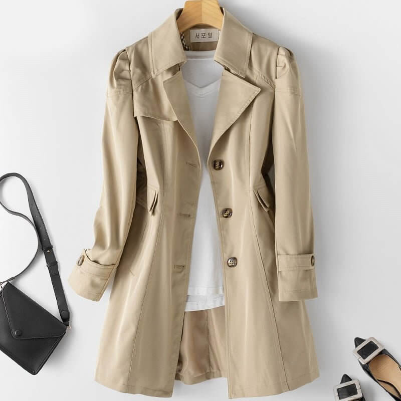 Chic women's long single-breasted trench coat. Fashionable outerwear for an elegant, professional look.