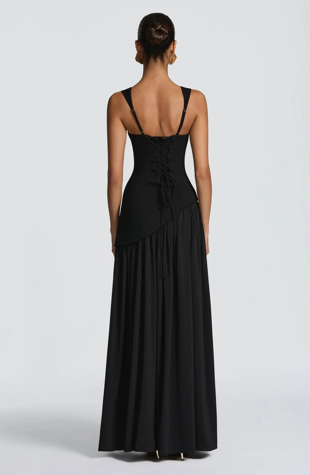 Close-up of a women's sleeveless A-line maxi dress, highlighting its fitted waist and elegant silhouette.