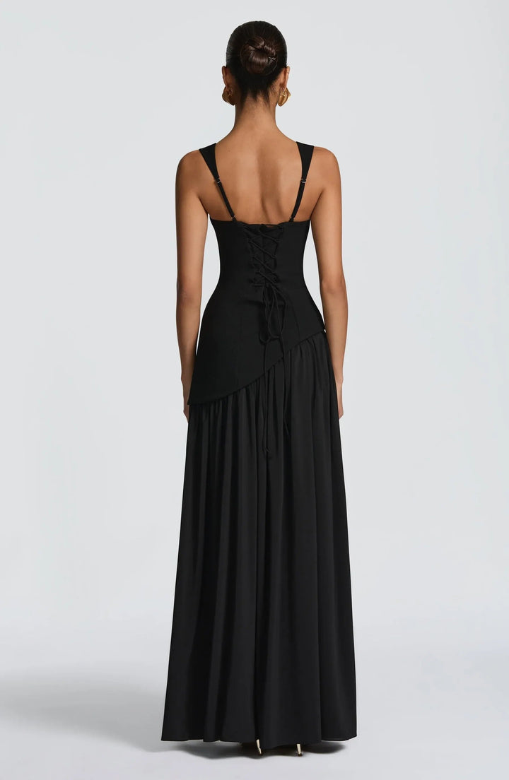 Close-up of a women's sleeveless A-line maxi dress, highlighting its fitted waist and elegant silhouette.