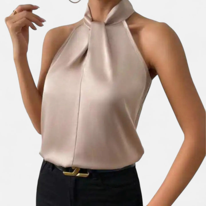 Close-up view of the unique twisted neck detail on a women's elegant sleeveless blouse. Office and evening ready.