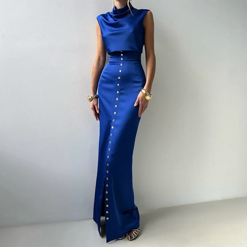 Elegant women's sleeveless button-up two-piece set, featuring a cropped top and flowy maxi skirt. Perfect summer occasion wear.