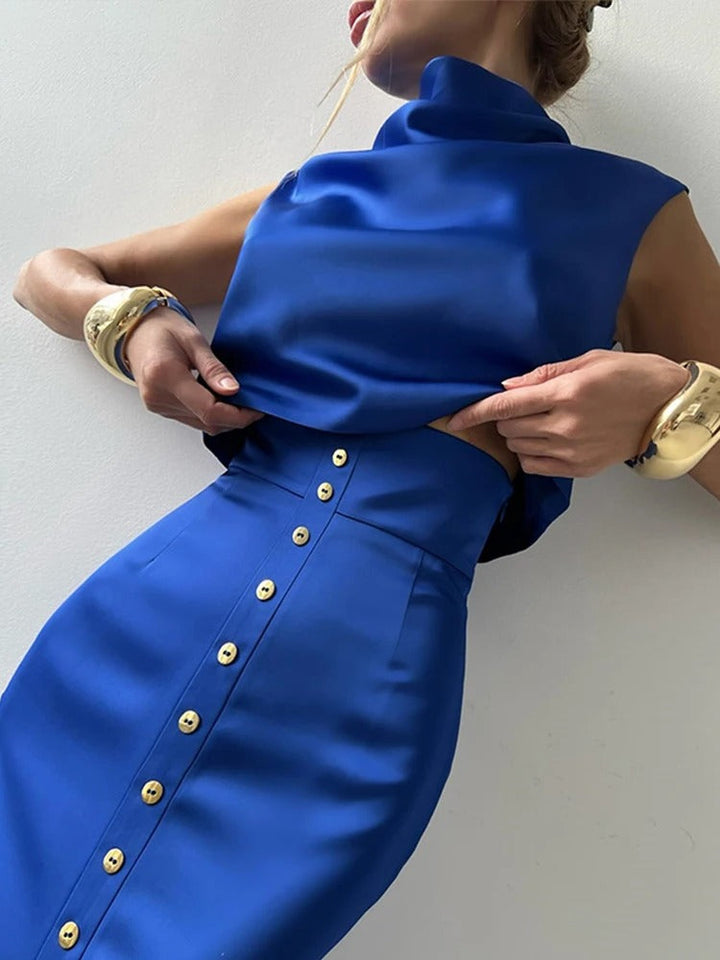 Stylish women's coordinated set with a sleeveless button-up crop top and matching high-waisted maxi skirt for summer fashion.