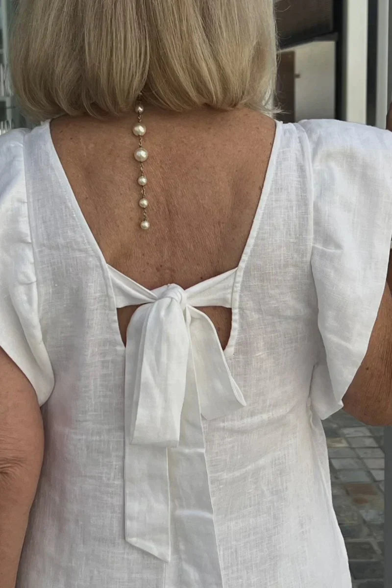 Stylish women's flowy sleeveless maxi dress, perfect for a chic summer beach look.