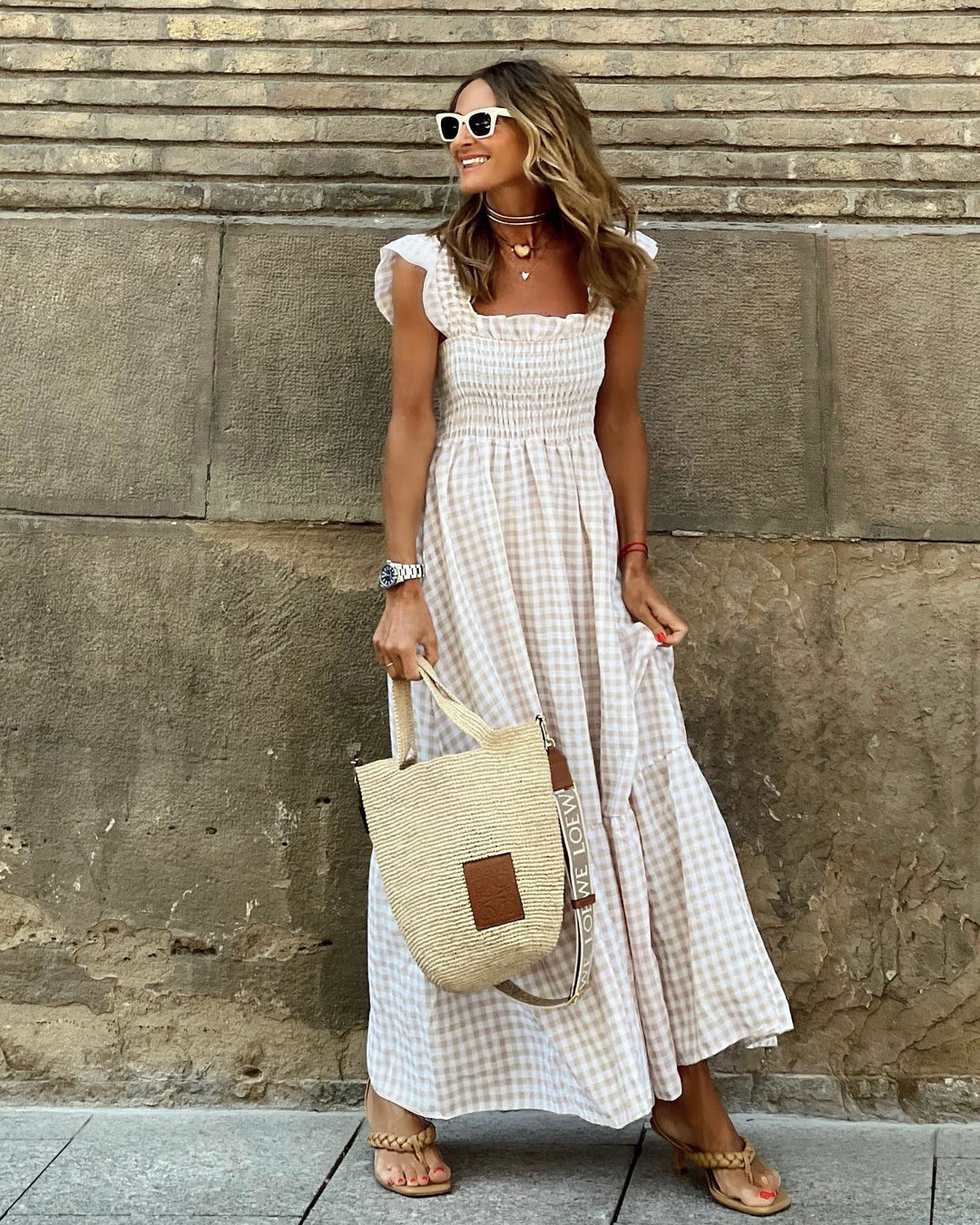 Elegant women's smocked plaid maxi dress with ruffled sleeves. Versatile for summer fashion.