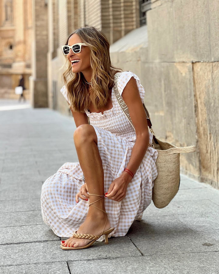 Smocked bodice & ruffled sleeves on this long plaid maxi dress for women. Stylish summer fashion.