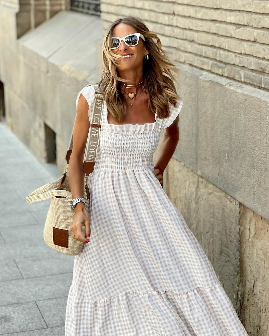 Versatile women's plaid maxi dress. Elegant smocked design with ruffled sleeves for casual or dressy summer wear.