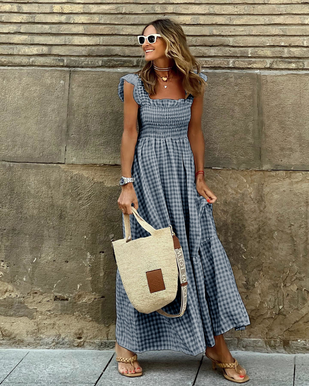 Comfortable yet elegant smocked plaid maxi dress for women. Features stylish ruffled sleeves for a versatile summer look.
