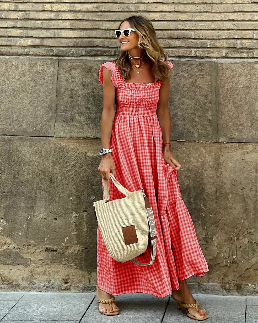 Long women's plaid maxi dress with an elegant smocked top and pretty ruffled sleeves. Perfect for summer style.