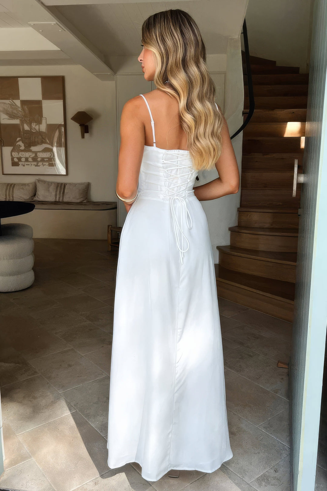 Women's elegant spaghetti strap maxi dress with a flowing A-line skirt and chic open back design.
