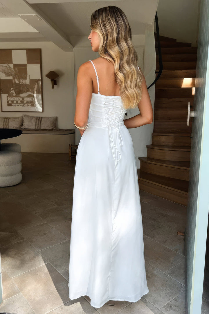 Women's elegant spaghetti strap maxi dress with a flowing A-line skirt and chic open back design.