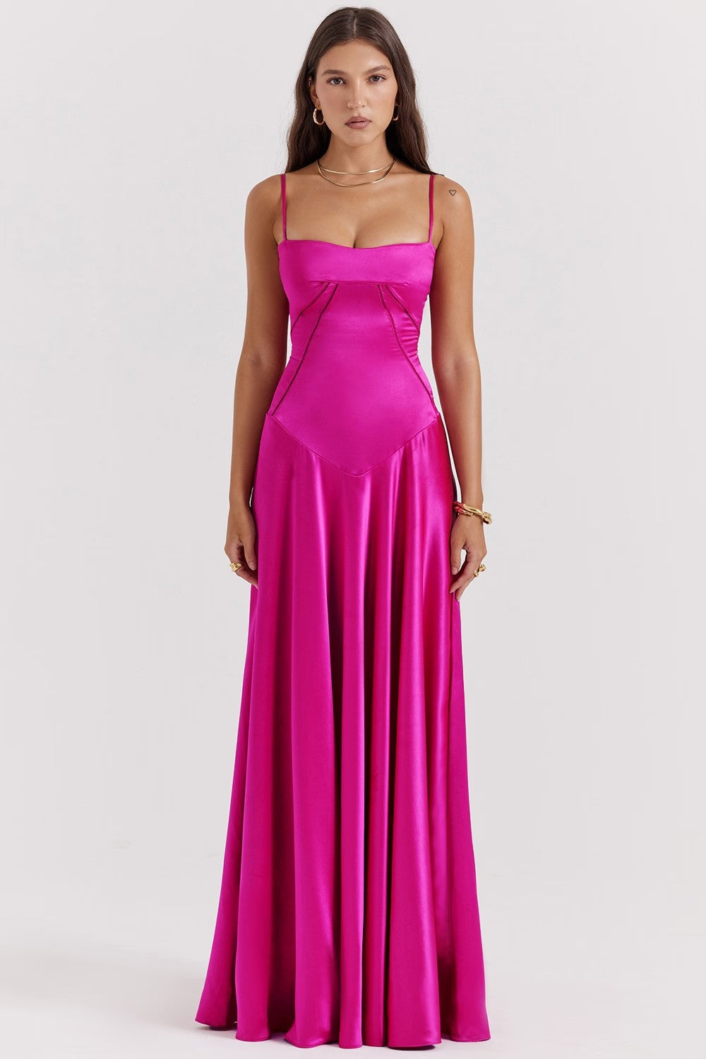 Women's flowing white maxi dress with delicate spaghetti straps. Elegant and comfortable for summer days.