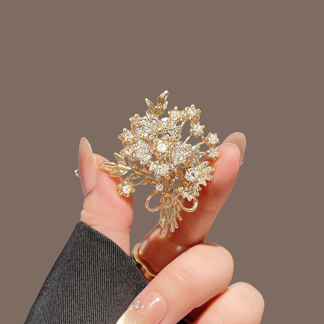 Delicate crystal leaf design brooch pin, women's fashion accessory with sparkling rhinestones.