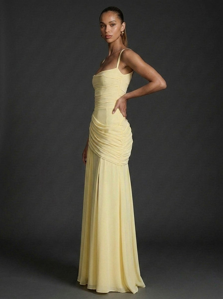 Chic sleeveless square-neck maxi dress with elegant ruching and draped fabric, suitable for summer occasions.