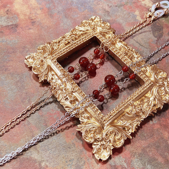 Elegant women's stainless steel chain necklace with striking red accent. Perfect fashion accessory for her.