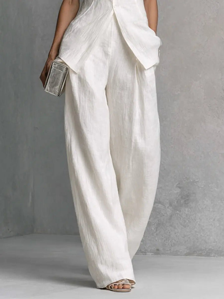 Women's elegant high-waisted wide-leg two-piece set. Features a stand-collar top with shell buttons.