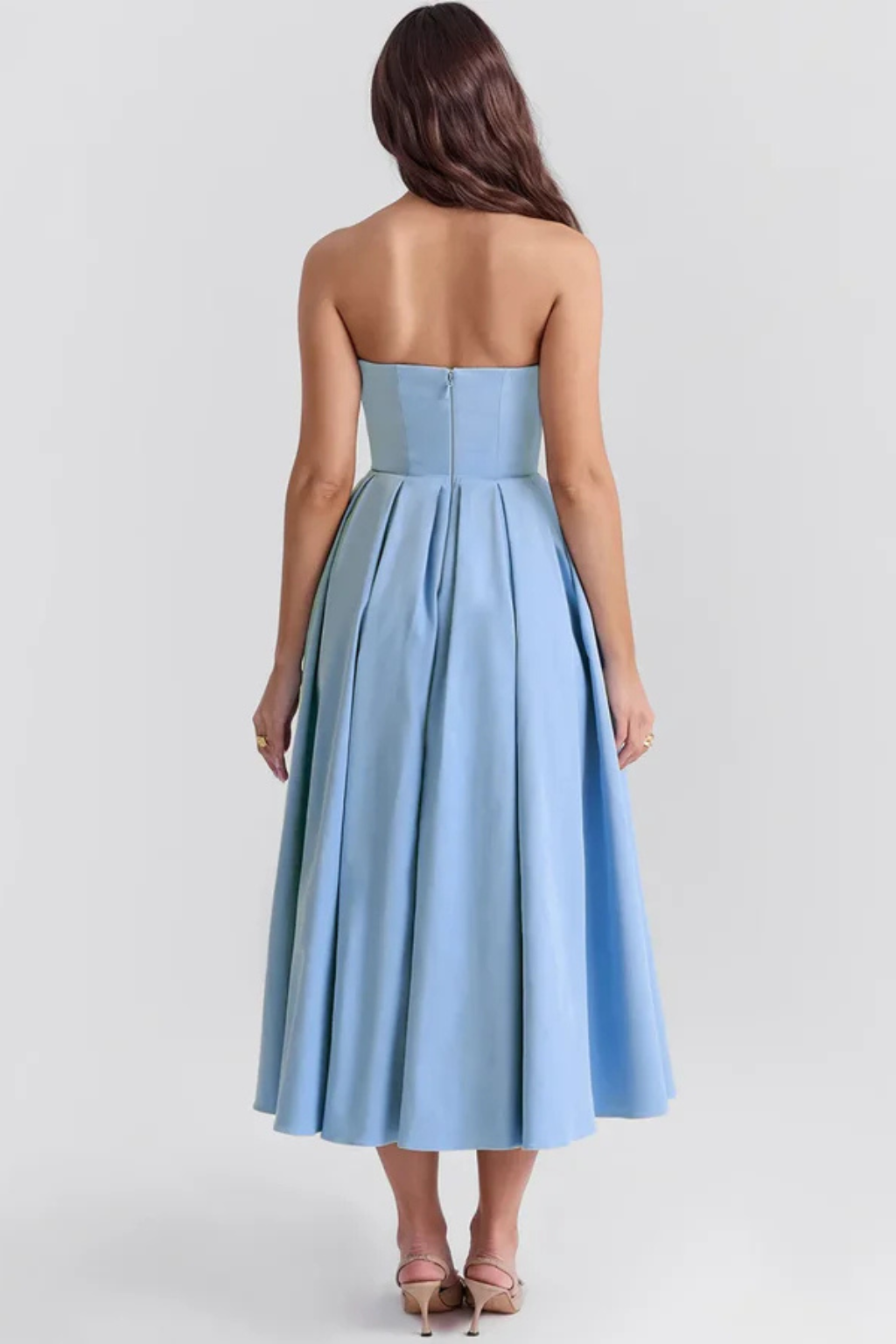 Women's elegant strapless corset midi dress with a beautiful flared skirt, ideal for formal evenings and special events.