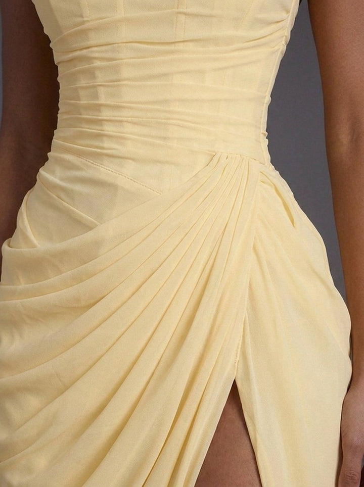 Close-up of the flattering corseted bodice and ruched details on a women's formal occasion maxi dress.
