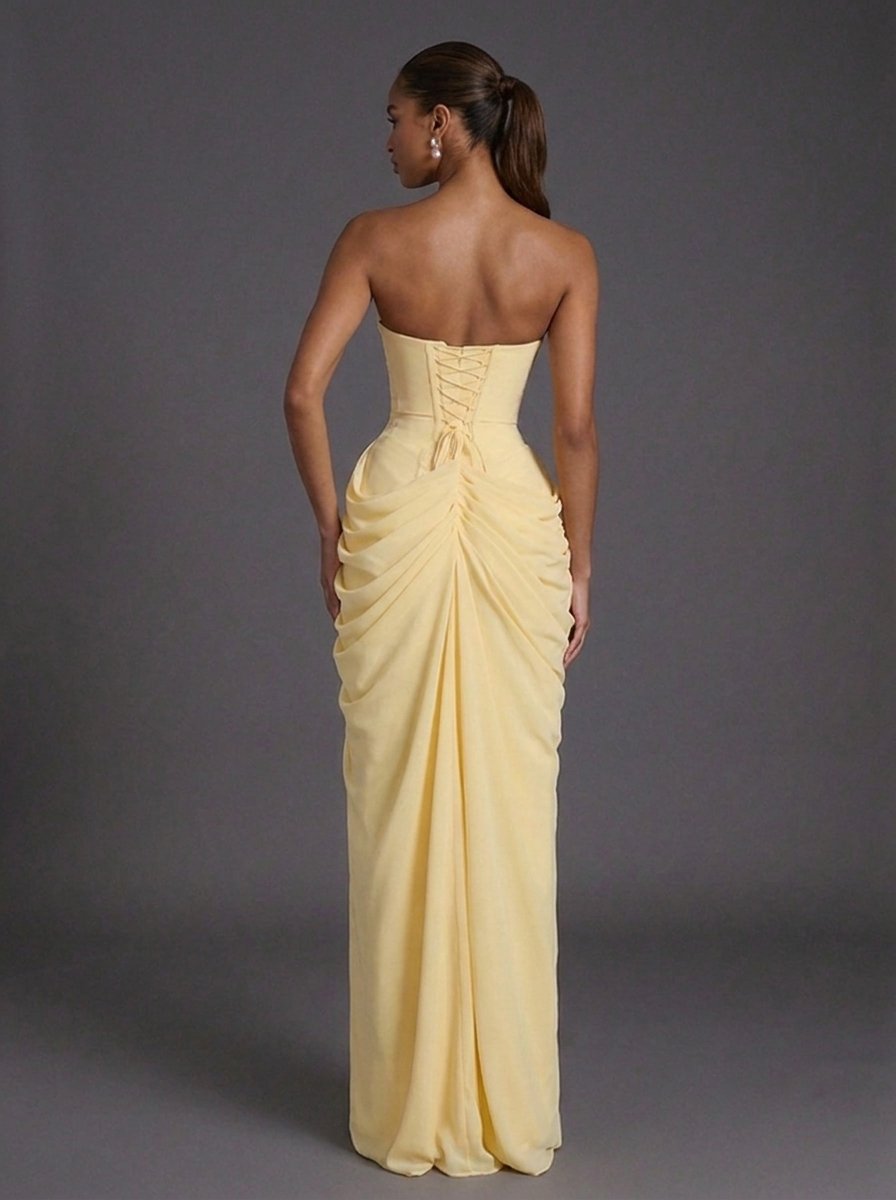 Sophisticated strapless maxi gown with a dramatic thigh-split, elegant for wedding guest or party attire.