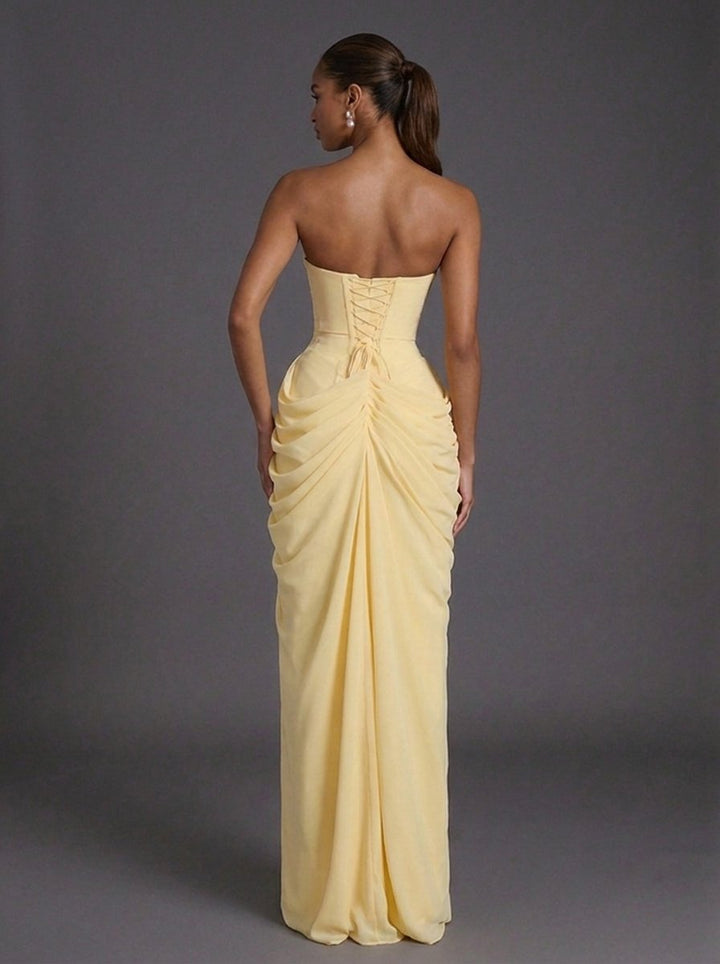 Sophisticated strapless maxi gown with a dramatic thigh-split, elegant for wedding guest or party attire.