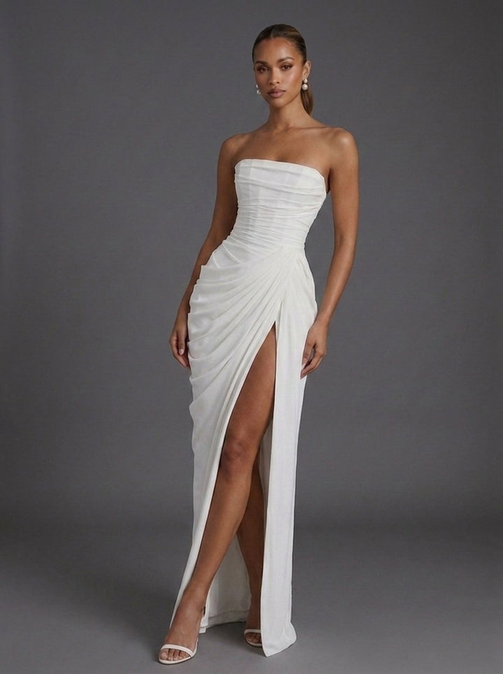 Stunning women's wedding guest maxi dress: strapless, corseted, ruched, and with a daring thigh-split.