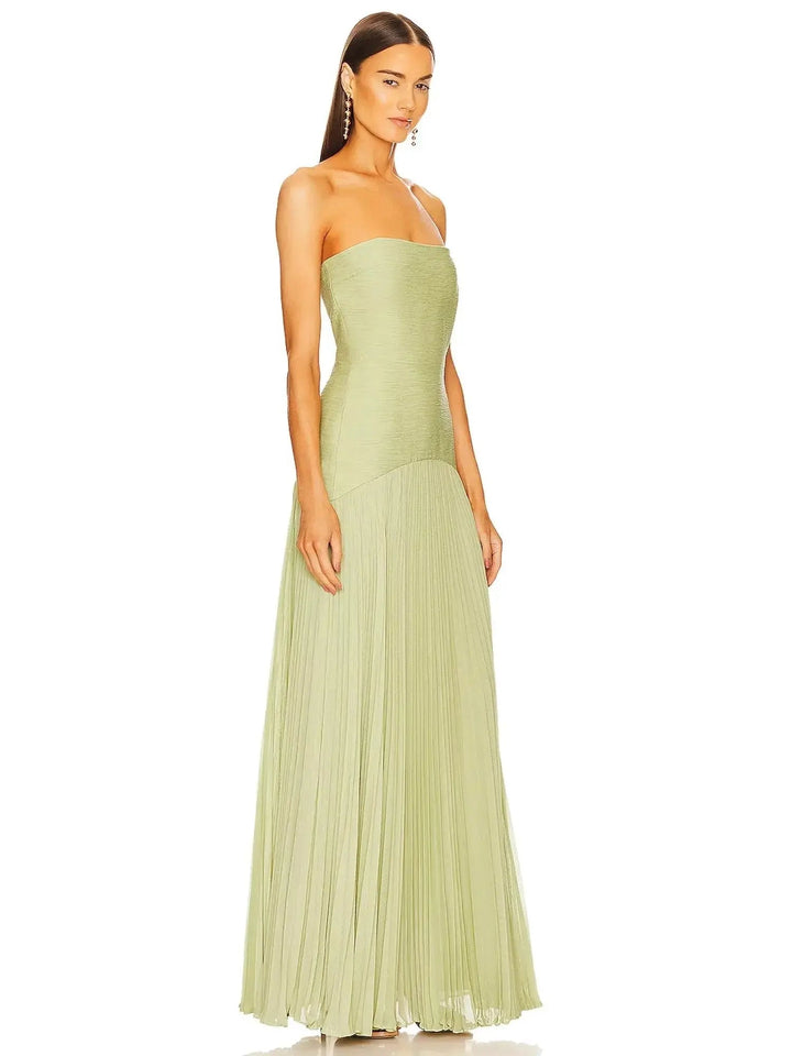 Stylish strapless maxi gown for women, featuring a pleated skirt, ideal for wedding guests & special evening events.