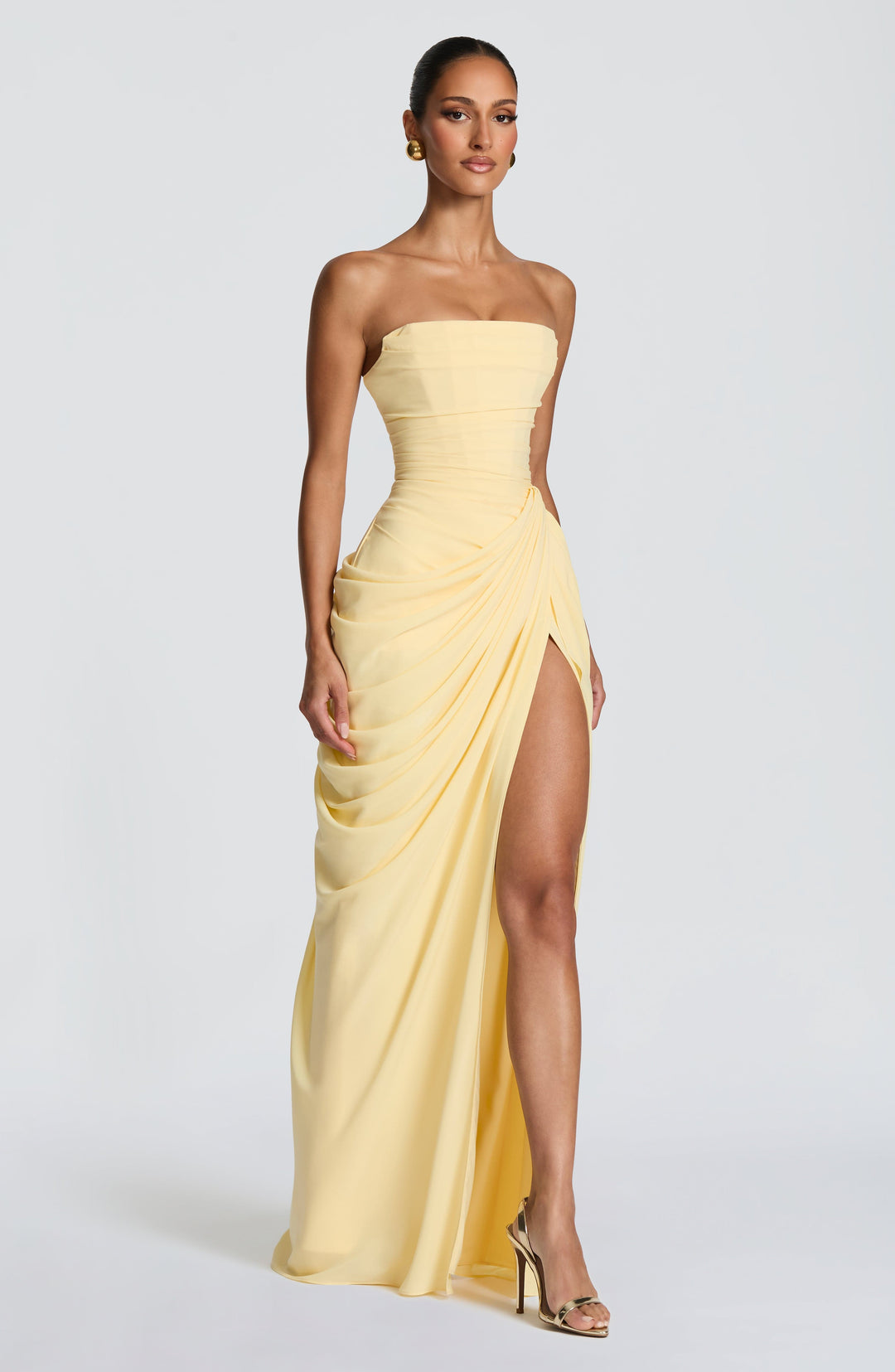 Formal women's strapless maxi dress in elegant navy, designed with a chic ruched waist for special occasions.