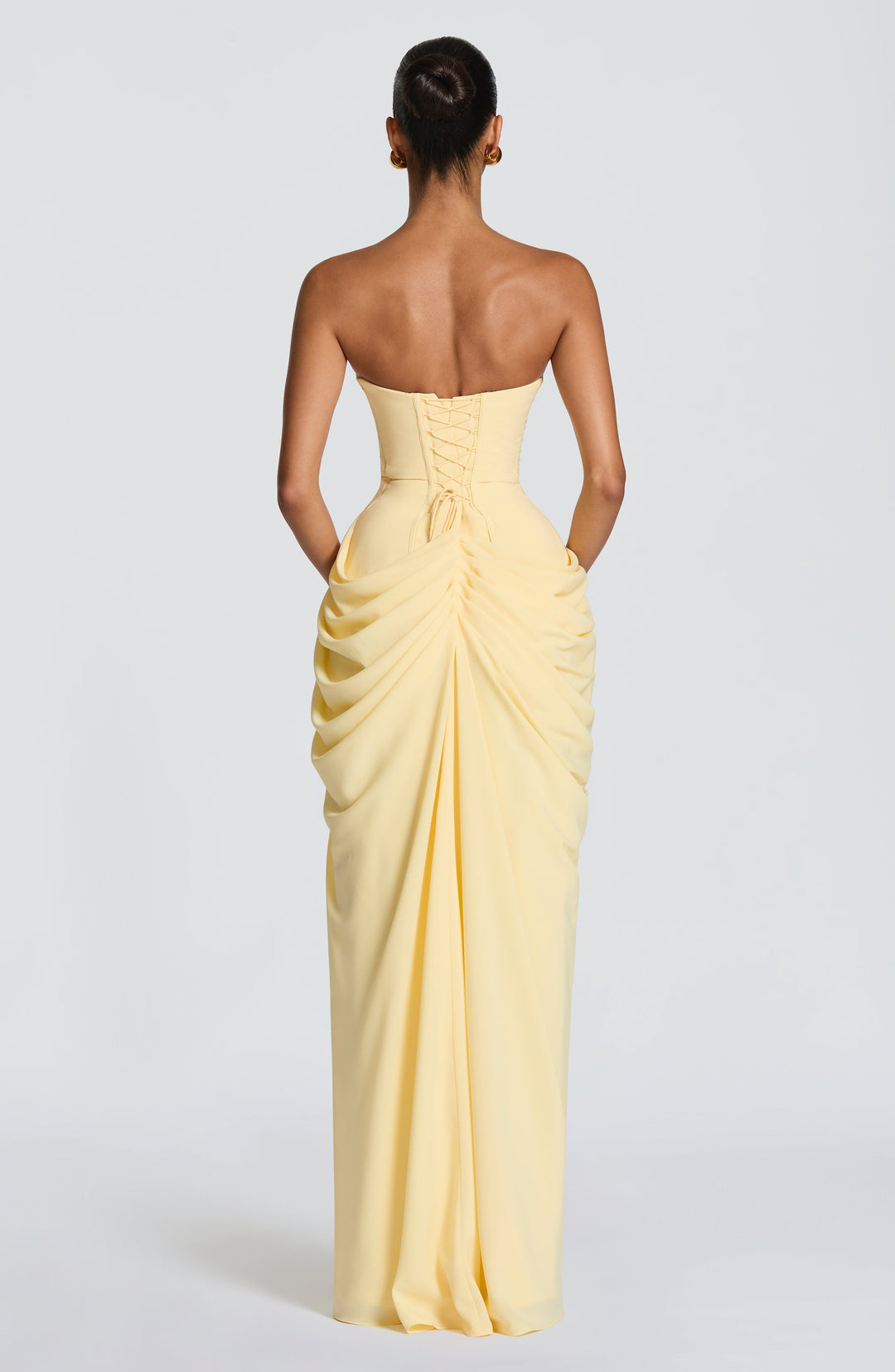 Luxurious women's strapless navy maxi dress, elegant design with a ruched waist and flowing drape.