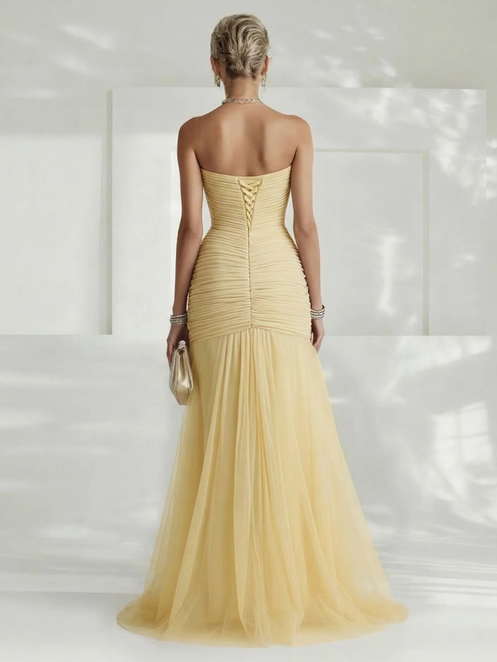 Stylish women's strapless pleated maxi dress. A long, flowing formal gown, excellent for elegant evening events.