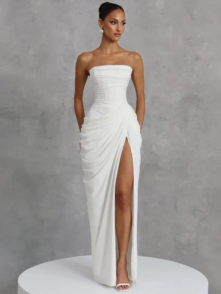 Full-length elegant women's strapless maxi dress. Features ruched detail, a high slit, suitable for formal events.