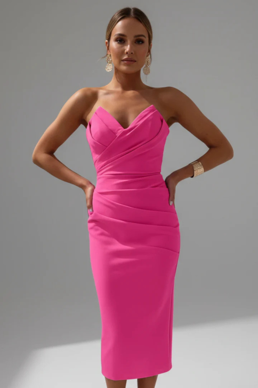 Sophisticated women's elegant strapless ruched sweetheart midi dress with a sleek fitted bodycon design.