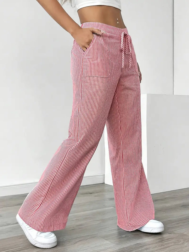 High-waist detail on women's striped pants with pockets, offering a flattering silhouette.