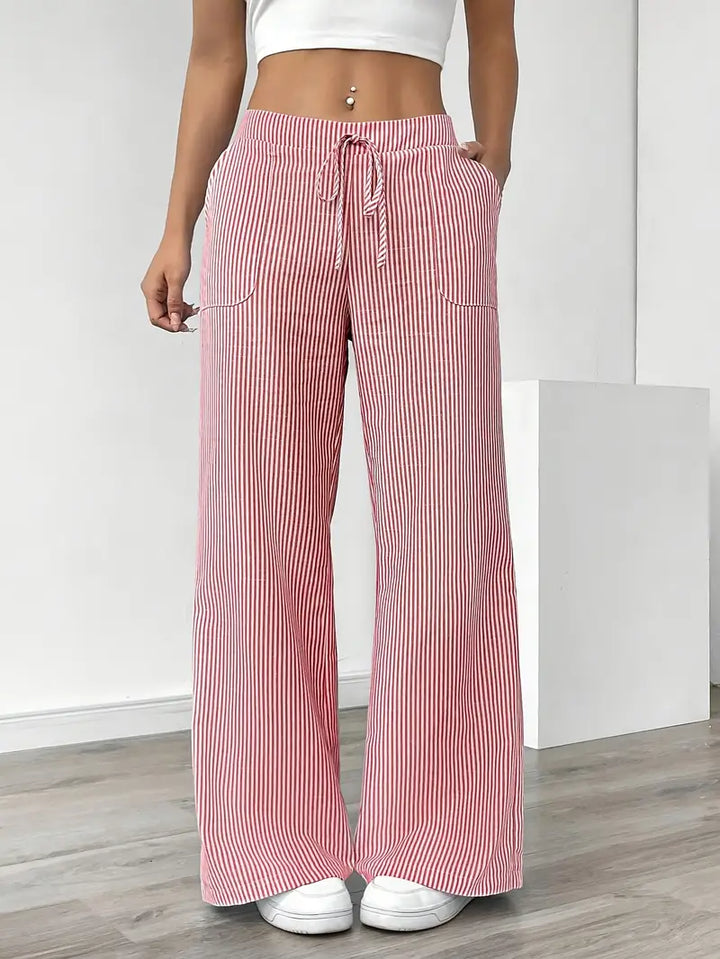 Comfortable wide-leg striped ladies trousers with pockets, ideal for casual wear.