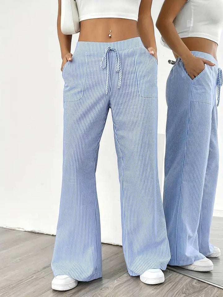 Modern striped high-waist pants for women, wide-leg cut with functional pockets.